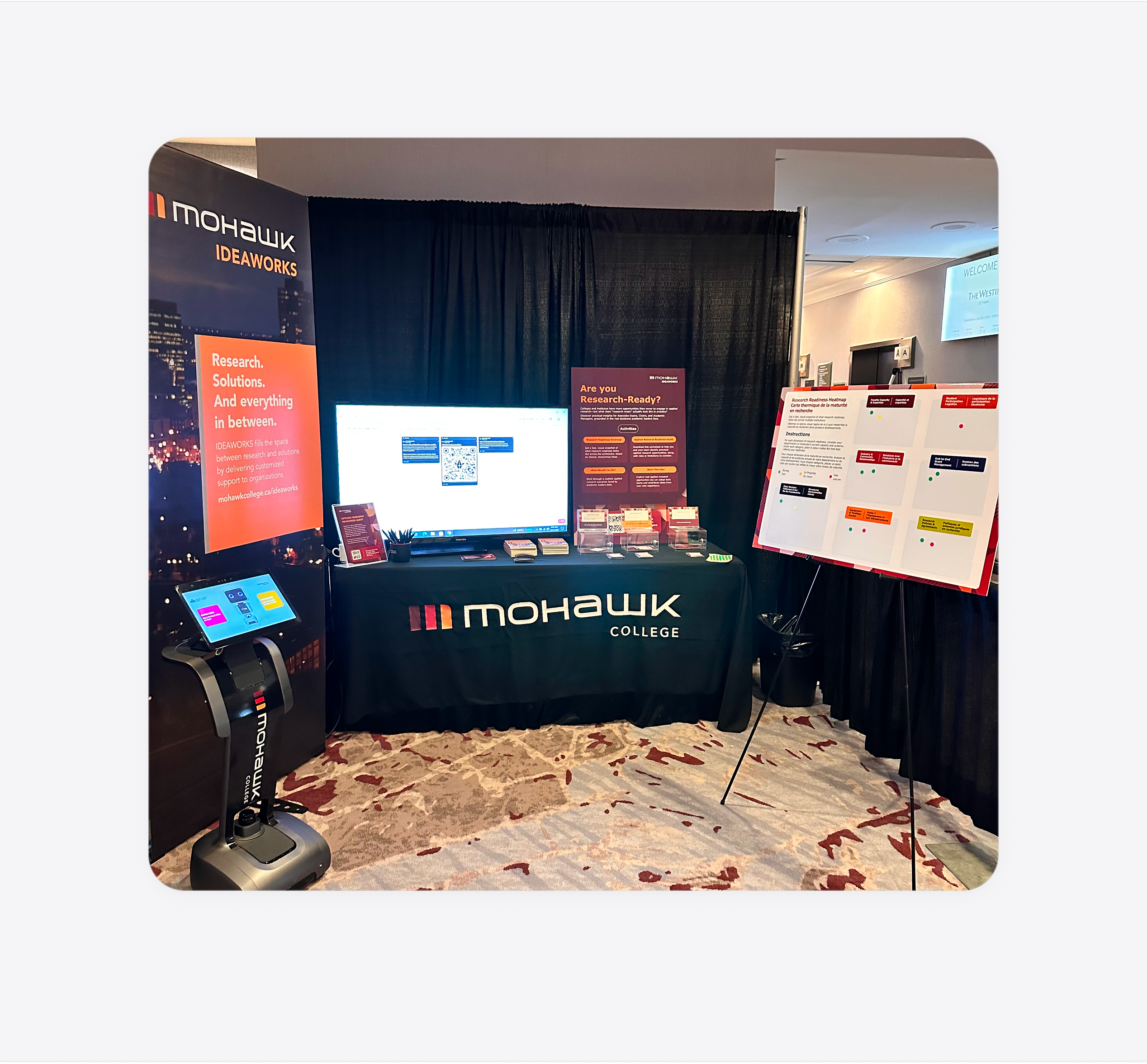 Mohawk IDEAWORKS booth at CiCan with materials, robot display, and research readiness board