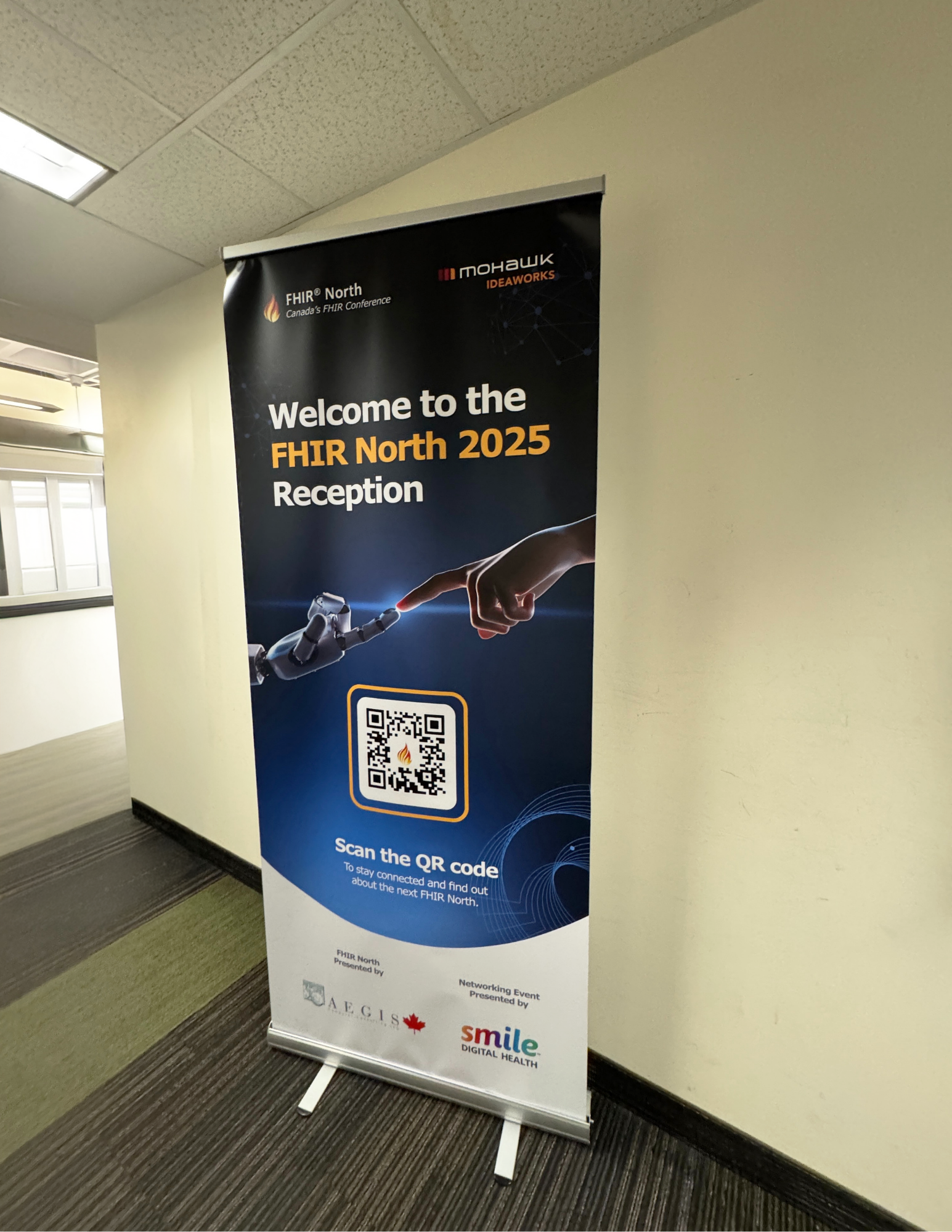 FHIR North roll-up banner displayed in a workplace hallway