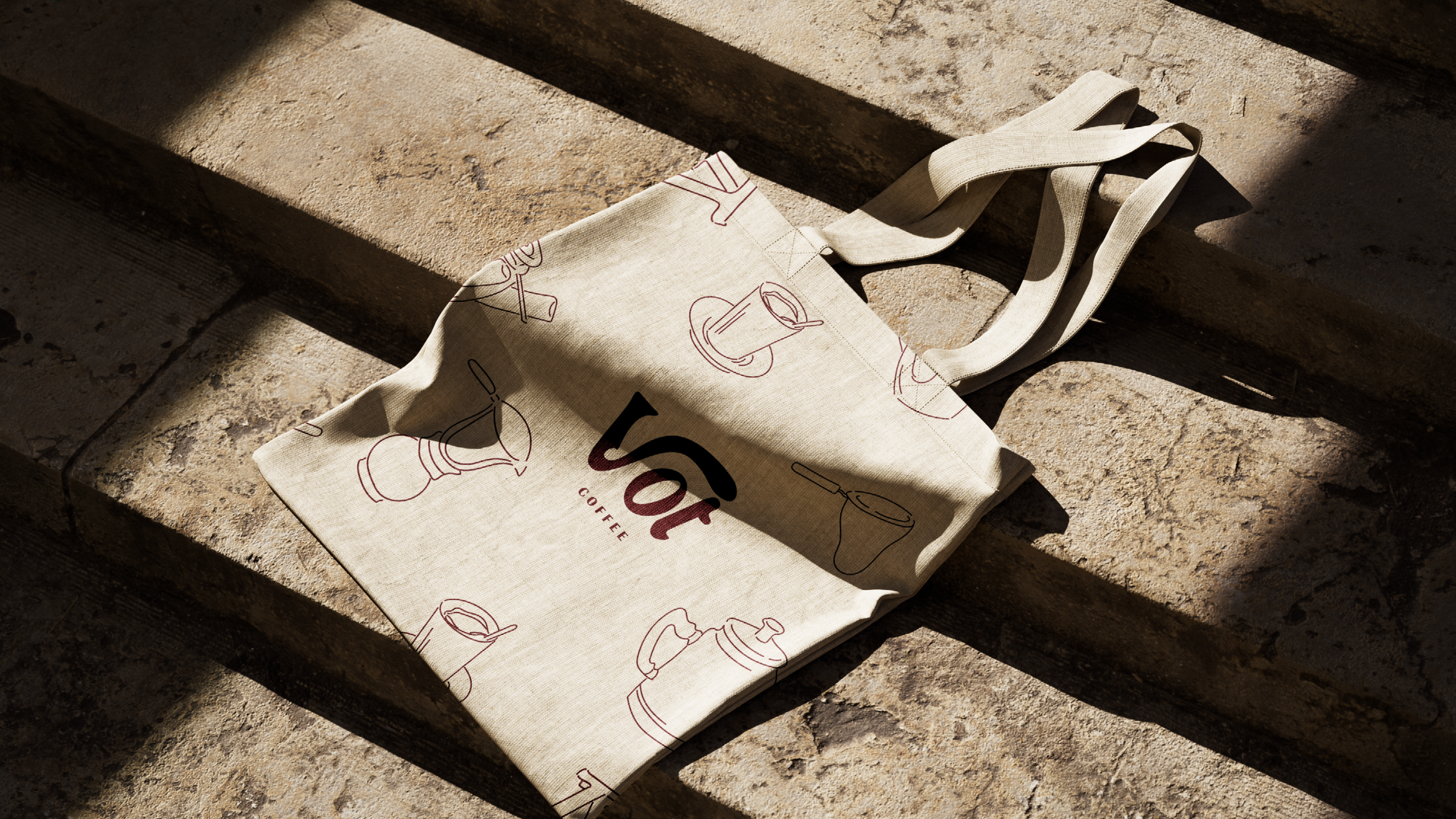 Canvas tote bag with Vot Coffee branding on stone steps